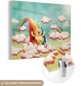 MuchoWow® Glasschilderij 80x60 cm - Schilderij acrylglas - Kinderillustratie karakter met konijnenpak glijdt van de regenboog - Foto op glas - Schilderijen