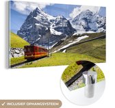 MuchoWow® Glasschilderij 40x20 cm - Schilderij acrylglas - Een rode trein met bergen op de achtergrond - Foto op glas - Schilderijen