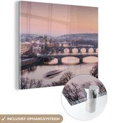MuchoWow® Glasschilderij 50x50 cm - Schilderij acrylglas - Praag - Winter - Architectuur - Foto op glas - Schilderijen