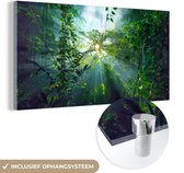 MuchoWow® Glasschilderij 160x80 cm - Schilderij acrylglas - De zon schijnend door de bossen van een regenwoud in Maleisië - Foto op glas - Schilderijen