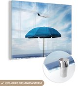 MuchoWow® Glasschilderij 120x90 cm - Schilderij acrylglas - Parasol - Wolken - Blauw - Foto op glas - Schilderijen