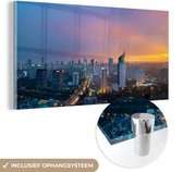 MuchoWow® Glasschilderij 40x20 cm - Schilderij acrylglas - Zonsondergang - Oranje - Jakarta - Foto op glas - Schilderijen