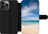 Bookcase Geschikt voor iPhone 13 Pro Max telefoonhoesje - Een tropisch strand op Hawaii waar de golven aanspoelen op - Met vakjes - Wallet case met magneetsluiting