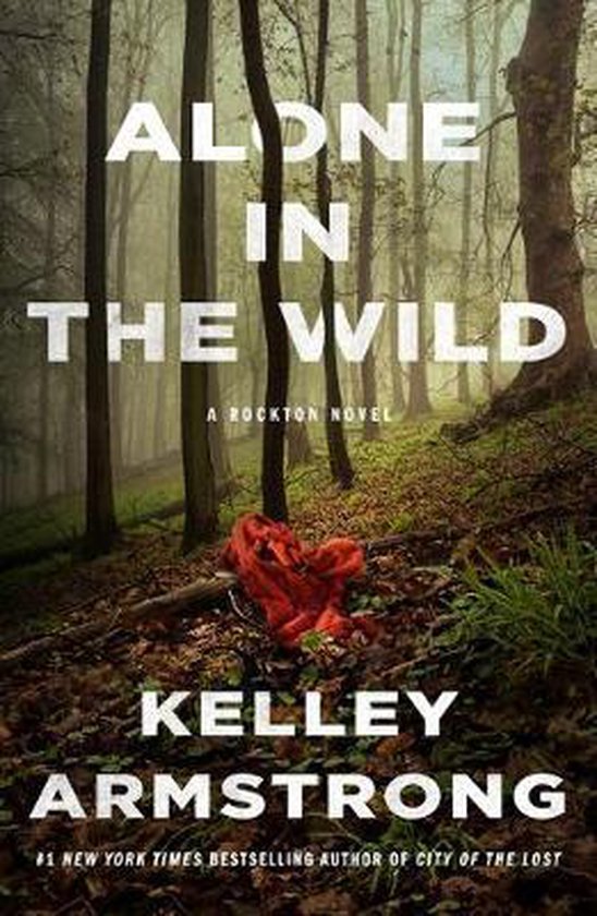 Boekomslag met de titel 'ALONE IN THE WILD' van KELLEY ARMSTRONG, in een bos met een rode doek op de grond.