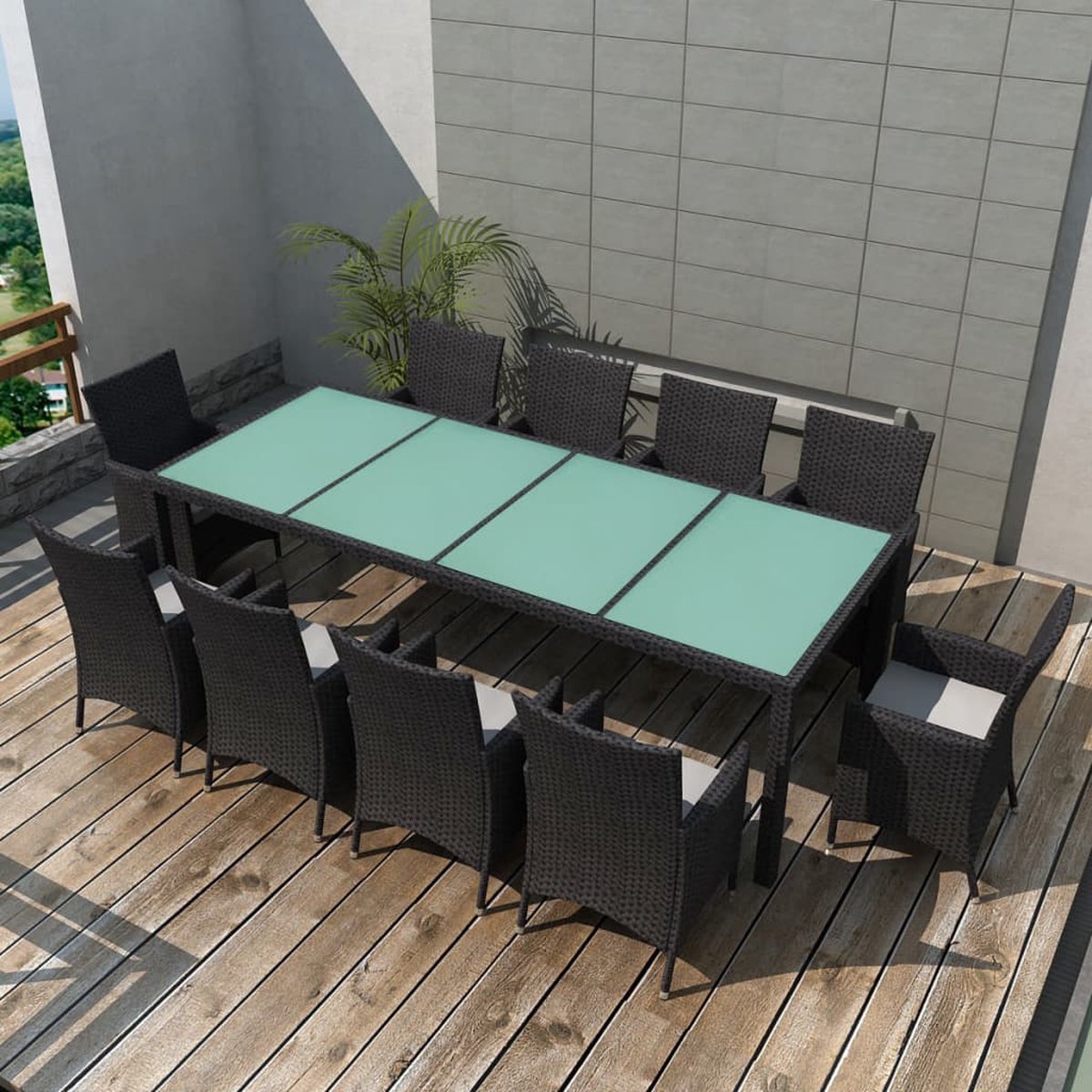 Tuinset met zwarte poly rattan meubels en kussens.