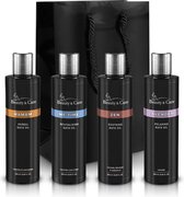 Vier flessen badolie van Beauty & Care: Hamam, Me Time, Zen en Lavender, met een zwarte cadeautas.