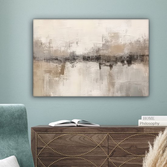 Tableau abstrait dans des tons beige, gris et brun avec texture, accroché au-dessus d'une commode avec des détails dorés et un livre ouvert.