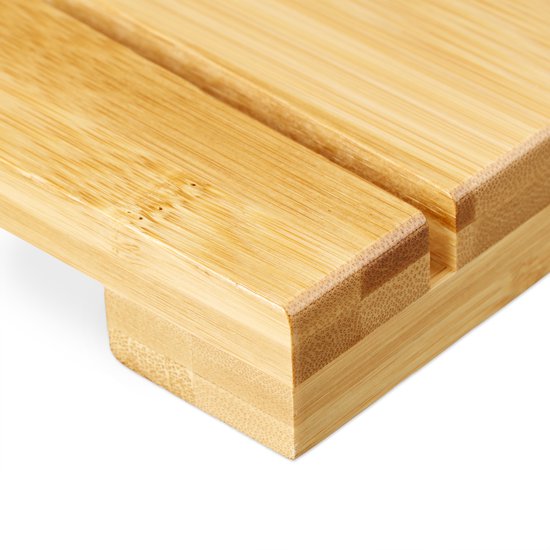 Close-up van de rand van een houten badmat met lamellenconstructie.
