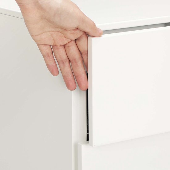 Hand die een lade van een wit ladeblok opent.