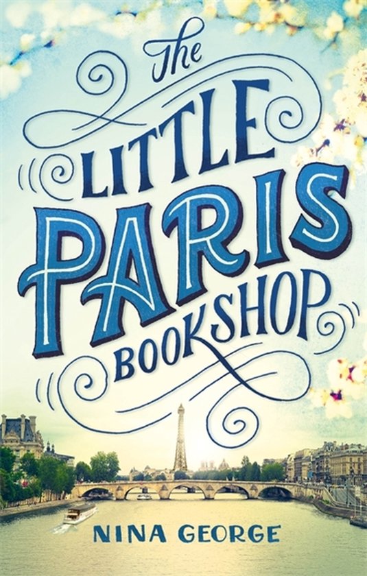 Boek 'The Little Paris Bookshop' met illustratie van de Eiffeltoren en de Seine.