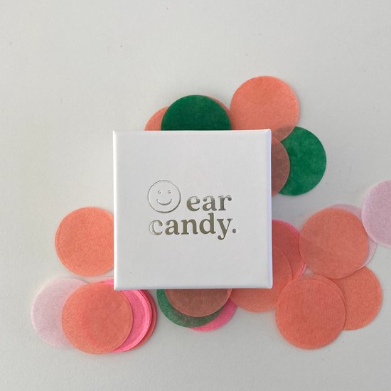 Wit Ear Candy doosje omringd door oranje, roze en groene confetti.