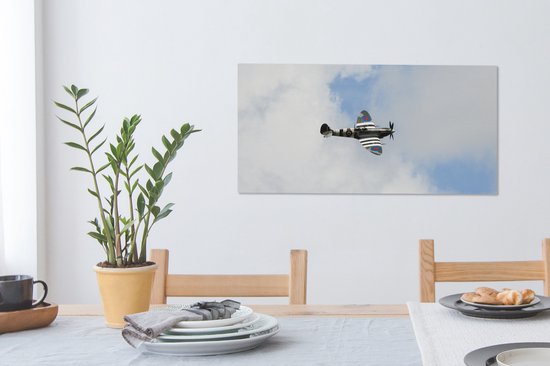 Tableau sur toile Avion Spitfire dans un ciel nuageux - 80x40 cm - Décoration murale