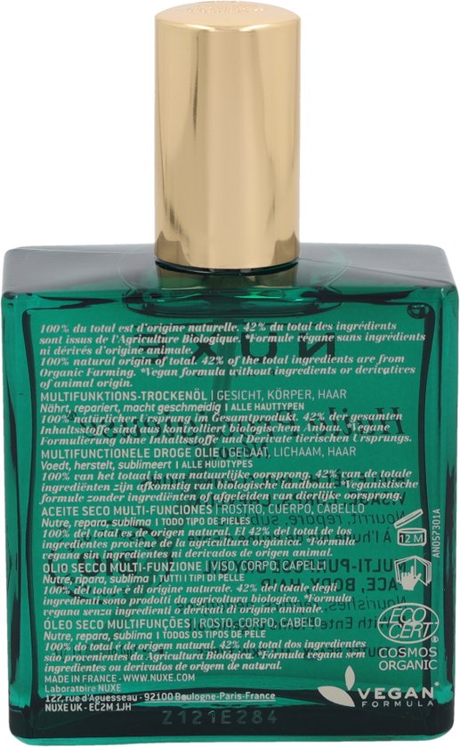 Achterkant van een groene Nuxe Huile Prodigieuse Néroli fles met gouden dop, met ingrediëntenlijst.