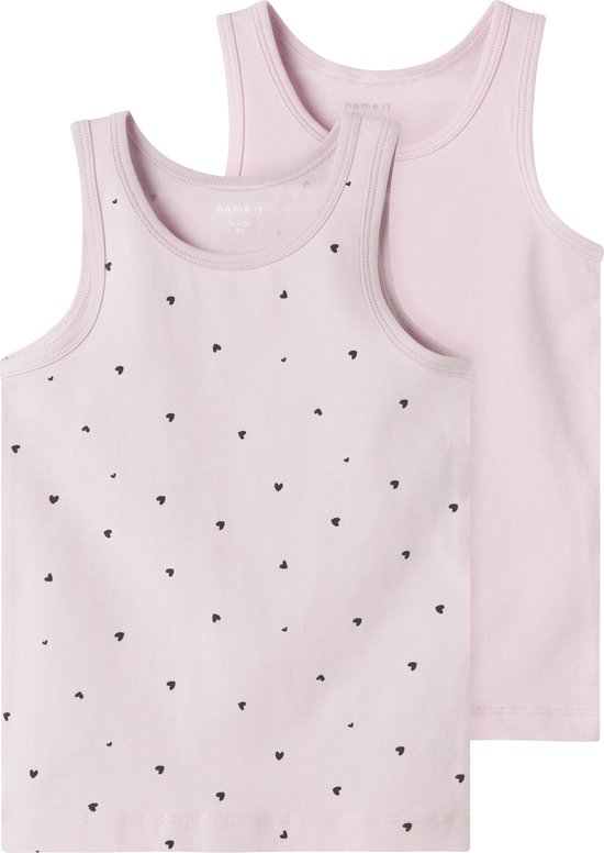 Twee roze hemdjes, het voorste met een all-over print van kleine zwarte hartjes.