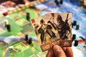Twee speelkaarten van "Rovers van de Noordzee" met Vikingen, getoond in een hand.