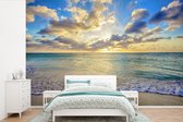 Behang - Fotobehang Zee - Strand - Wolken - Zon - Breedte 600 cm x hoogte 400 cm