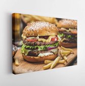 Canvas schilderij - Hamburgers and French fries on the wooden tray.  -     1040760661 - 50*40 Horizontal