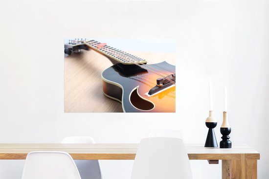 Une guitare électrique sur un plancher en bois Poster 90x60 cm - Tirage photo sur Poster (décoration murale salon / chambre)