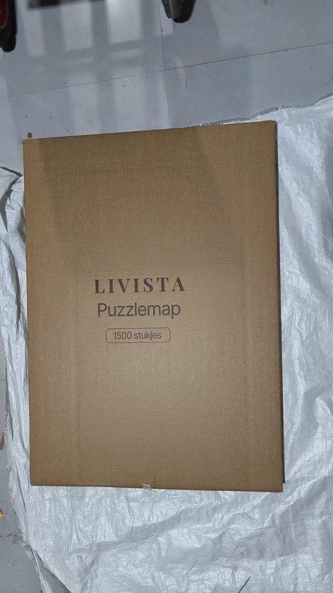 Bruine kartonnen doos met Livista Puzzlemmap en "1500 stukjes" erop.