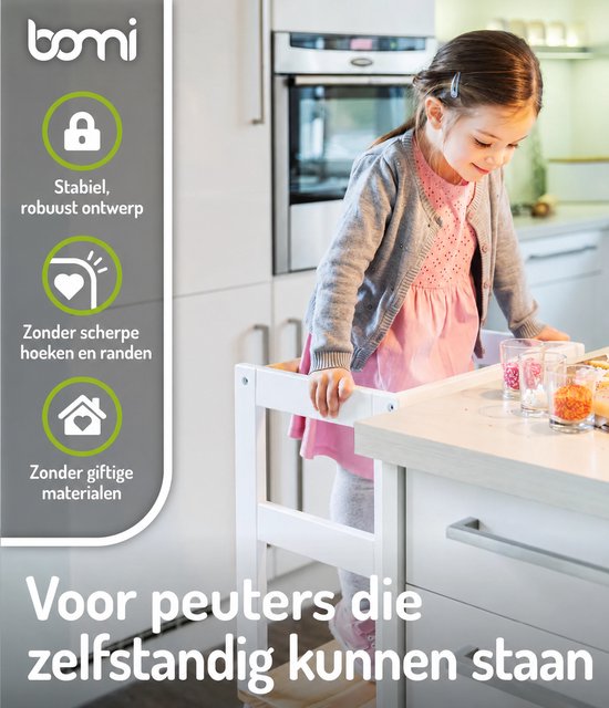 Meisje in grijze vest en roze jurk staat in een witte keukentoren. Met "Stabiel, robuust ontwerp".