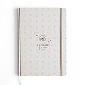 Off-white agenda 2027 met subtiel bloemenpatroon en elastische sluiting.