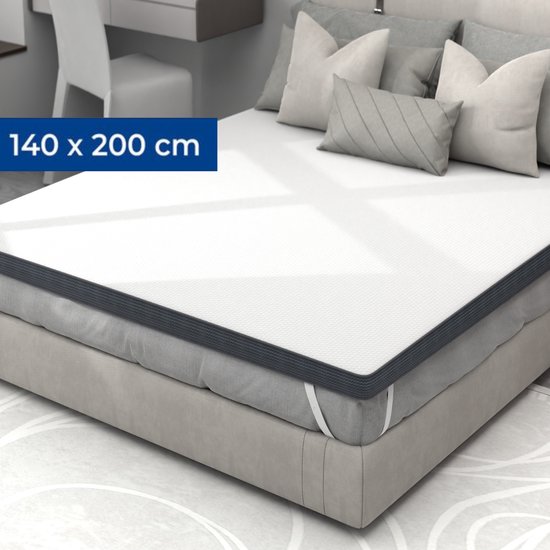 Un matelas blanc de 140x200 cm, fait avec des oreillers gris dans une chambre.