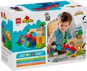 Doos van LEGO Duplo Spidey-Rex vs. Green Goblin met speelgoed en kind.