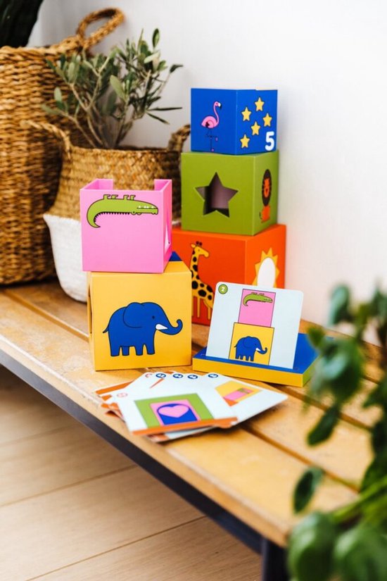 Gekleurde stapelblokken met dieren zoals een olifant, krokodil en flamingo. Speelgoed op een houten bankje.