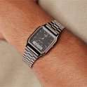 Zilverkleurig metalen horloge met zwart vierkant display om de pols van een man. Digitale tijd 4:21'17.
