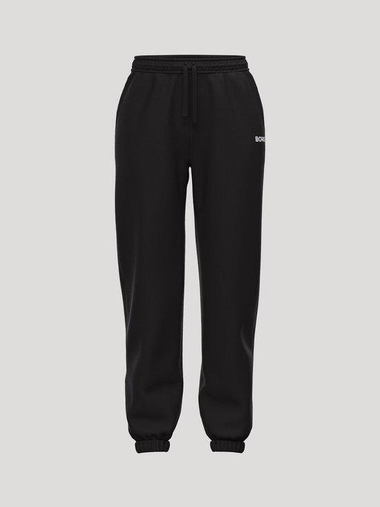 Zwarte Björn Borg joggingbroek voor dames, vooraanzicht. Met trekkoord en wit logo.