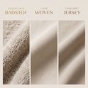 Drie close-ups van verschillende stoffen: een badstof, een geweven stof en een jersey stof.