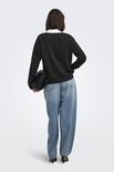 Model van achteren gezien in zwarte sweater, jeans en zwarte tas.