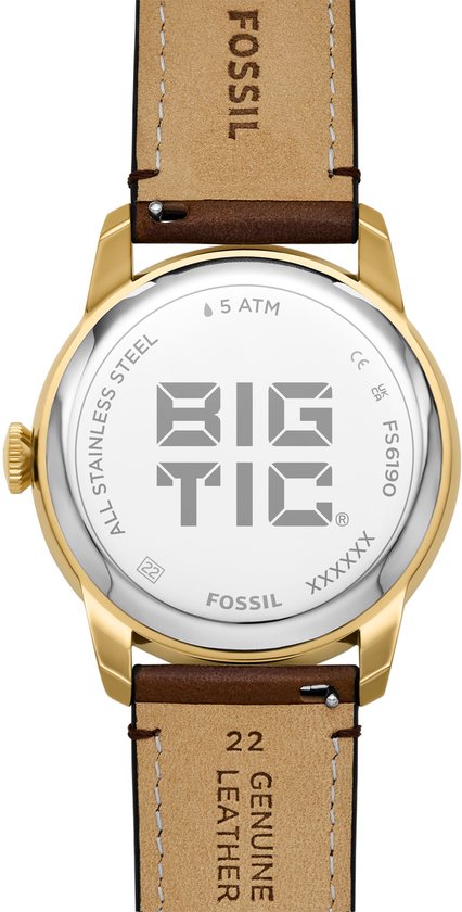 Gouden Fossil horlogekast met 'BIG TIC' logo en bruin lederen band met 'GENUINE LEATHER' tekst.