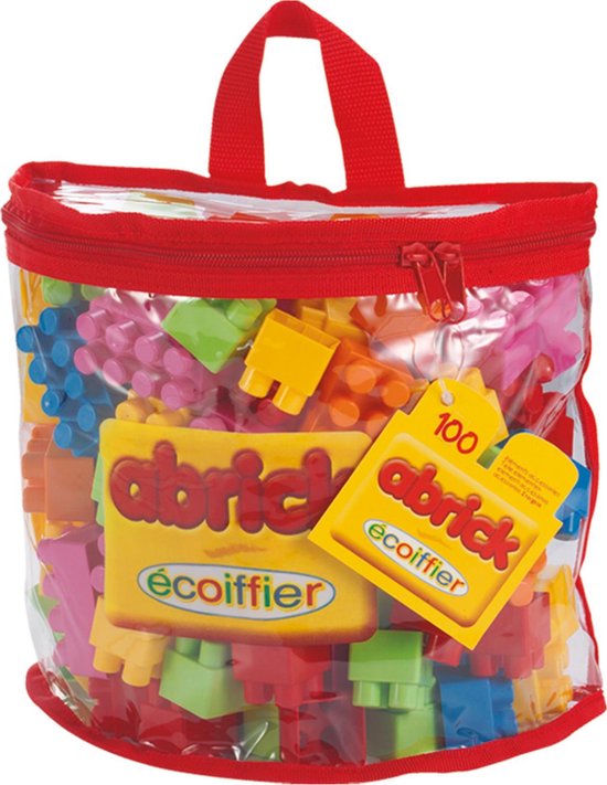 Un sac de transport transparent avec fermeture éclair et poignée rouges, rempli de 100 blocs de construction Abrick multicolores.