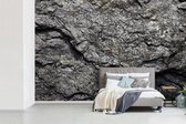 Behang - Fotobehang Glimmende rotsen structuur in Zwitserland - Breedte 420 cm x hoogte 280 cm