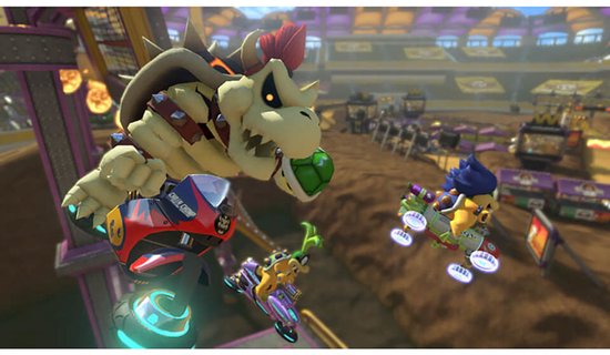 Bowser Jr. in een kart met een lachend gezicht op een ruig circuit met andere personages.