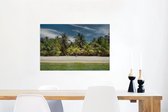 Canvas Schilderij Een zandstrand vol met palmbomen op Baai-eilanden in Noord-Amerika - 60x40 cm - Wanddecoratie