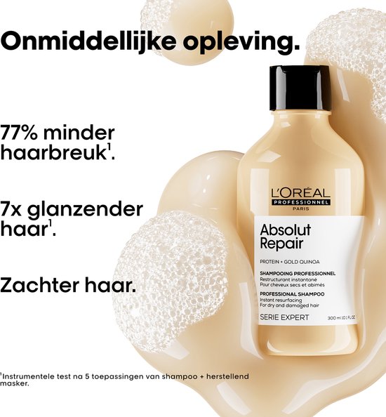 Shampoing L'Oréal Professionnel Absolut Repair dans une bouteille beige, entouré de mousse. Texte : 'Restauration immédiate', '77% de casse en moins', '7x plus de brillance', 'Cheveux plus doux'.