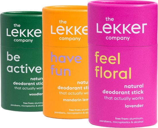 Drie deodorantstokken in de kleuren groen, oranje en roze.