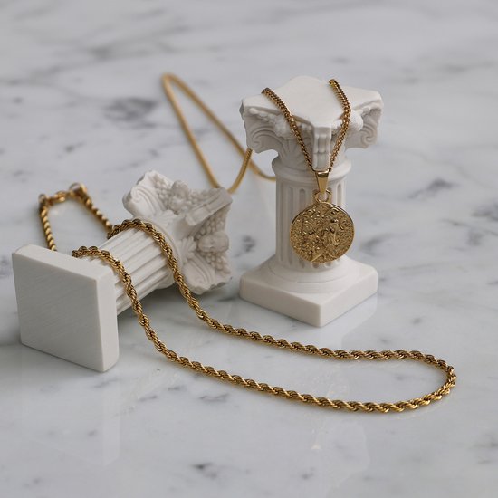 Gouden ketting met een muntvormige hanger met een afbeelding van twee figuren, staand op marmeren sokkels.