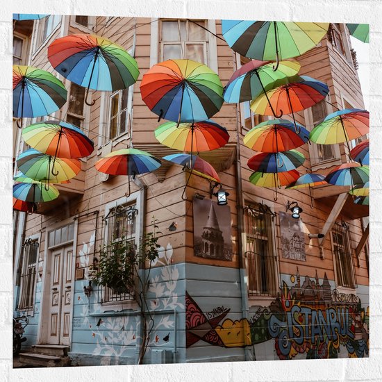 Muursticker - Plafond van Kleurrijke Paraplu's in Dorpssystraat - 80x80 cm Foto op Muursticker