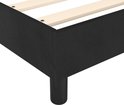 Detail van een zwart bedframe met houten latten en een zwarte poot.
