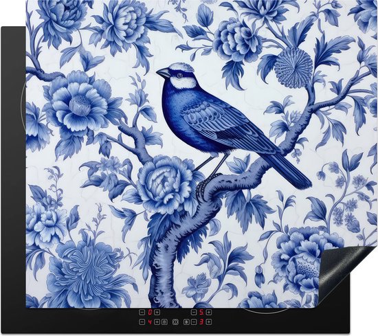 Inductiebeschermer met Delfts Blauw patroon van een vogel op een bloemtak, liggend op een inductiekookplaat.