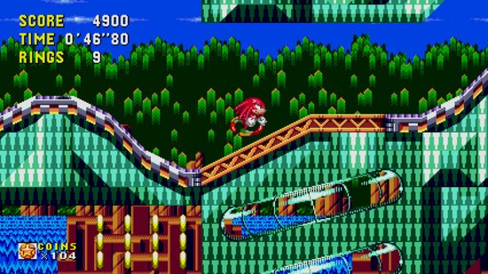Knuckles in het rood in de lucht, springend over een groen en blauw platform.