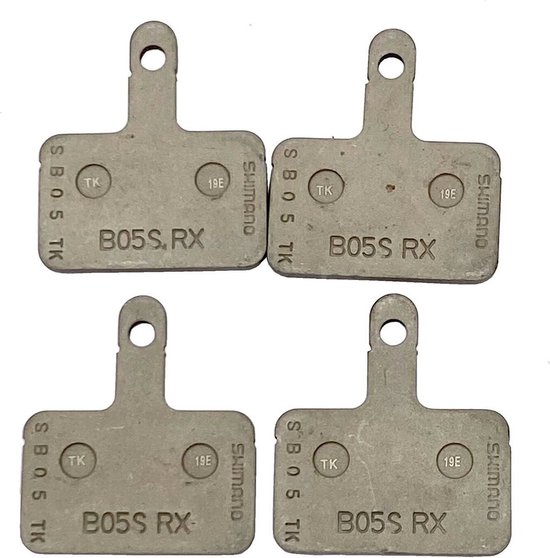 Quatre plaquettes de frein Shimano B05S RX grises avec des détails argentés.