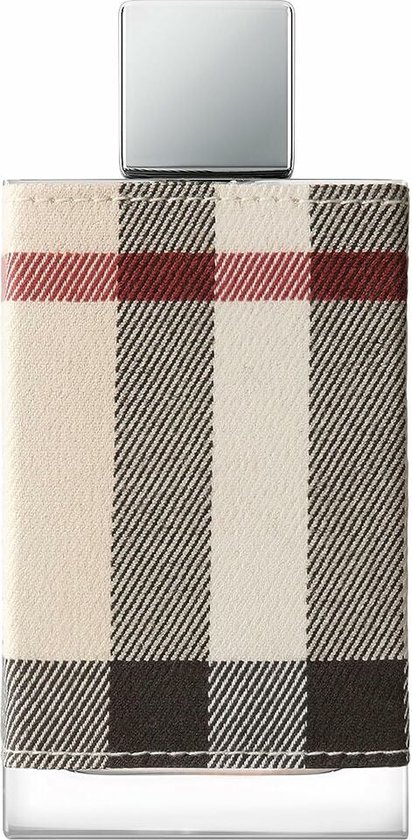 Flacon de parfum en verre enveloppé de tissu écossais beige, orné d'un motif écossais rouge, noir et blanc et d'un bouchon argenté.