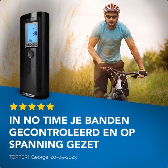 Zwarte Donrox compressor met digitaal display, naast een man in fietskleding op een fiets.
