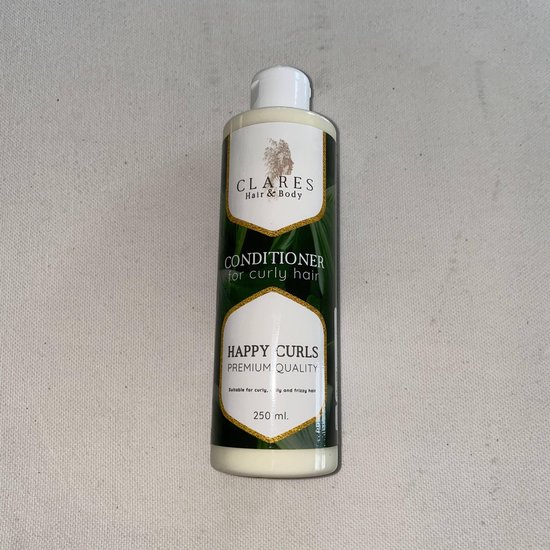 Bouteille de revitalisant avec imprimé de feuilles vertes, accents dorés. CLARÈS HAIR & BODY, HAPPY CURLS CONDITIONER pour cheveux bouclés, 250 ml.
