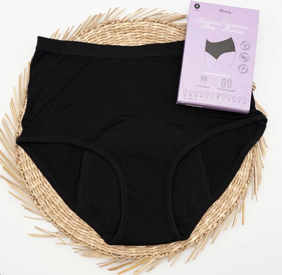 Culotte noire taille haute, modèle Madelief, posée sur un dessous de plat en osier à côté de son emballage.