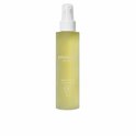 Gele fles met witte pomp, met het label 'BOUCLÈME curls redefined revive 5 hair oil'.